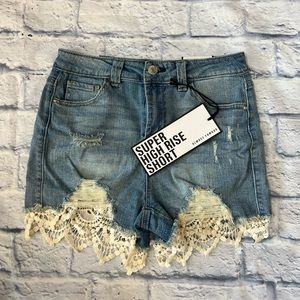 Blue high waisted ripped jeans with floral design size 3